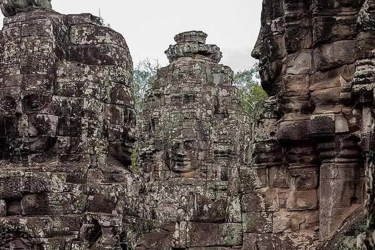 two stone faces on the side of a building