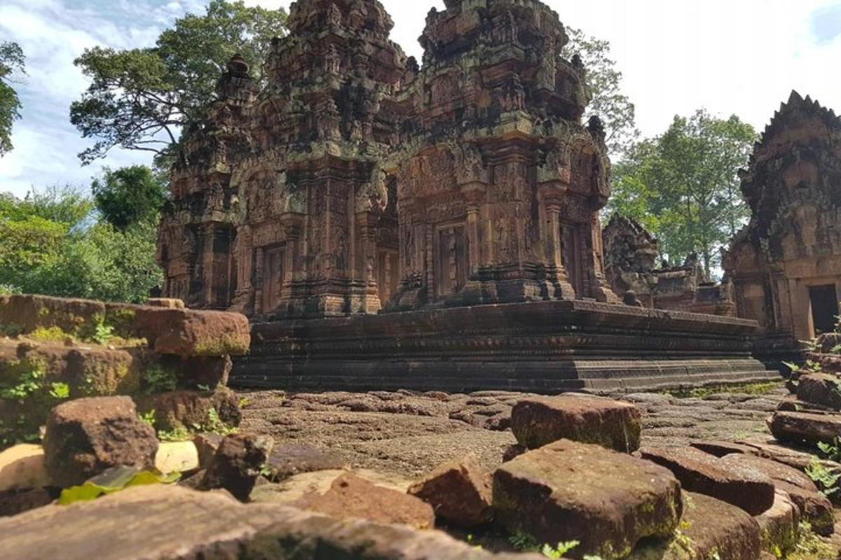 an old stone building with rocks in front of it