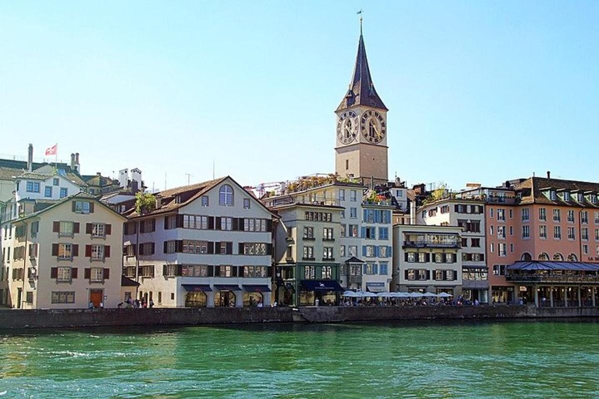 a city with a clock tower and a river
