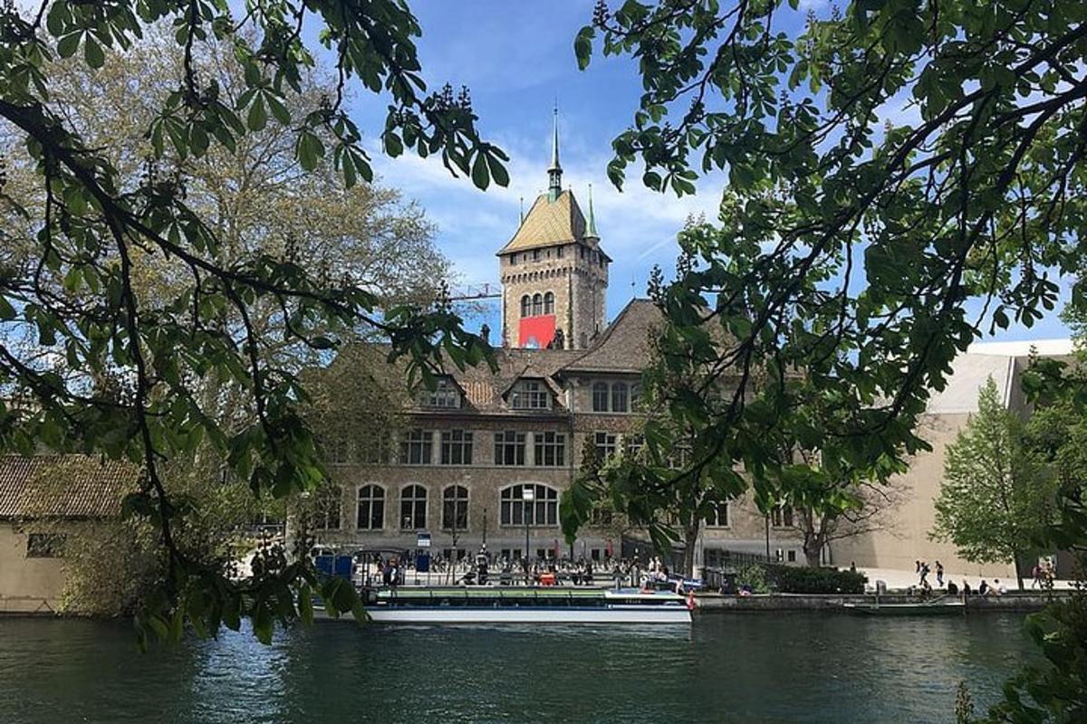 a large building with a tower and a boat in the water