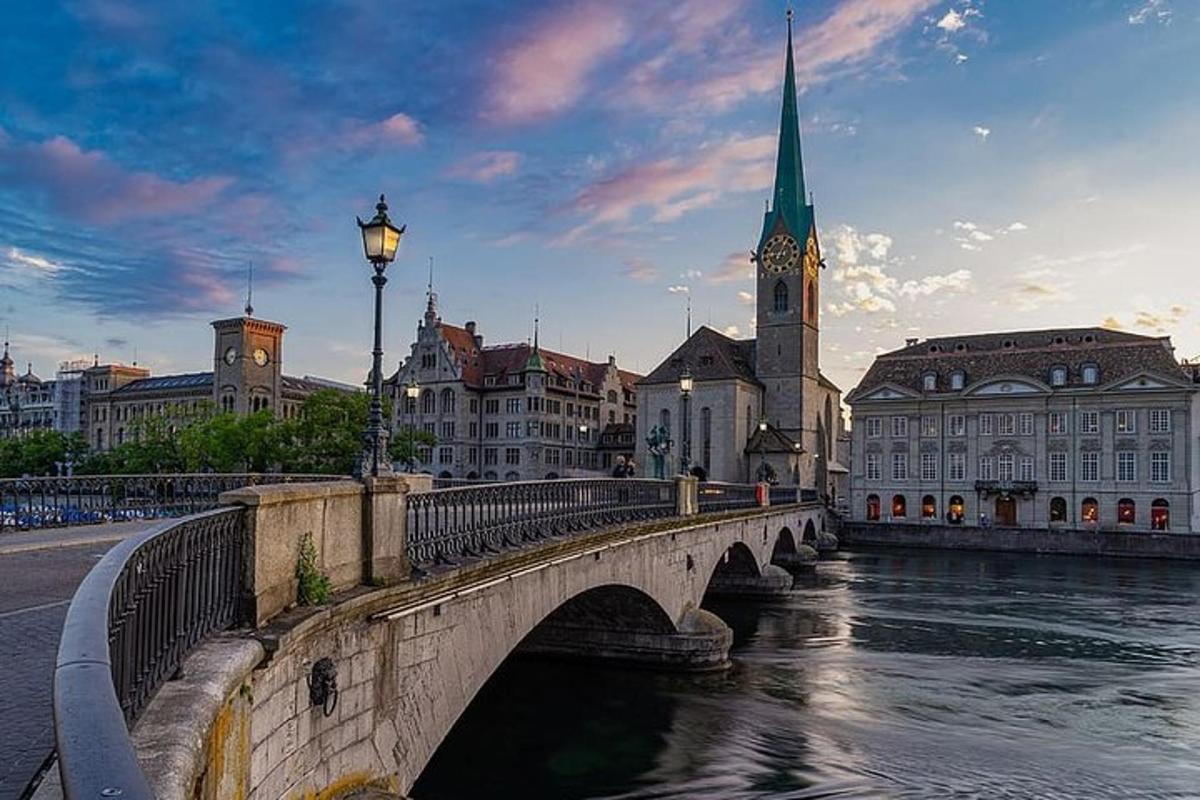 a bridge over a river in a city with a church