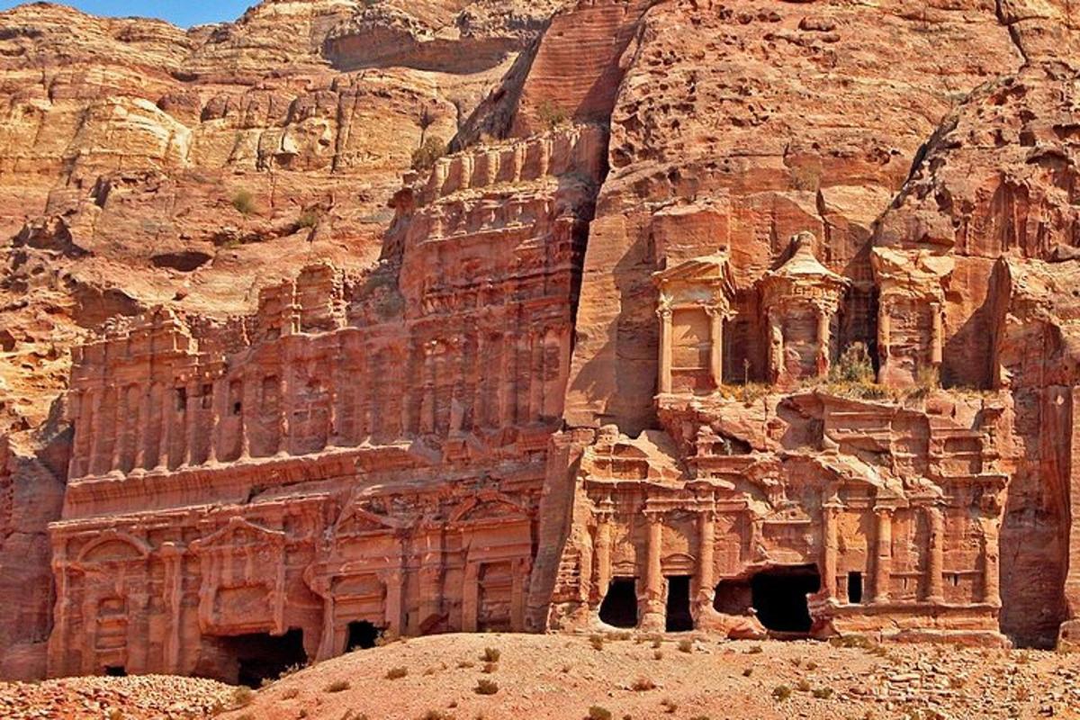 an ancient building in the side of a cliff