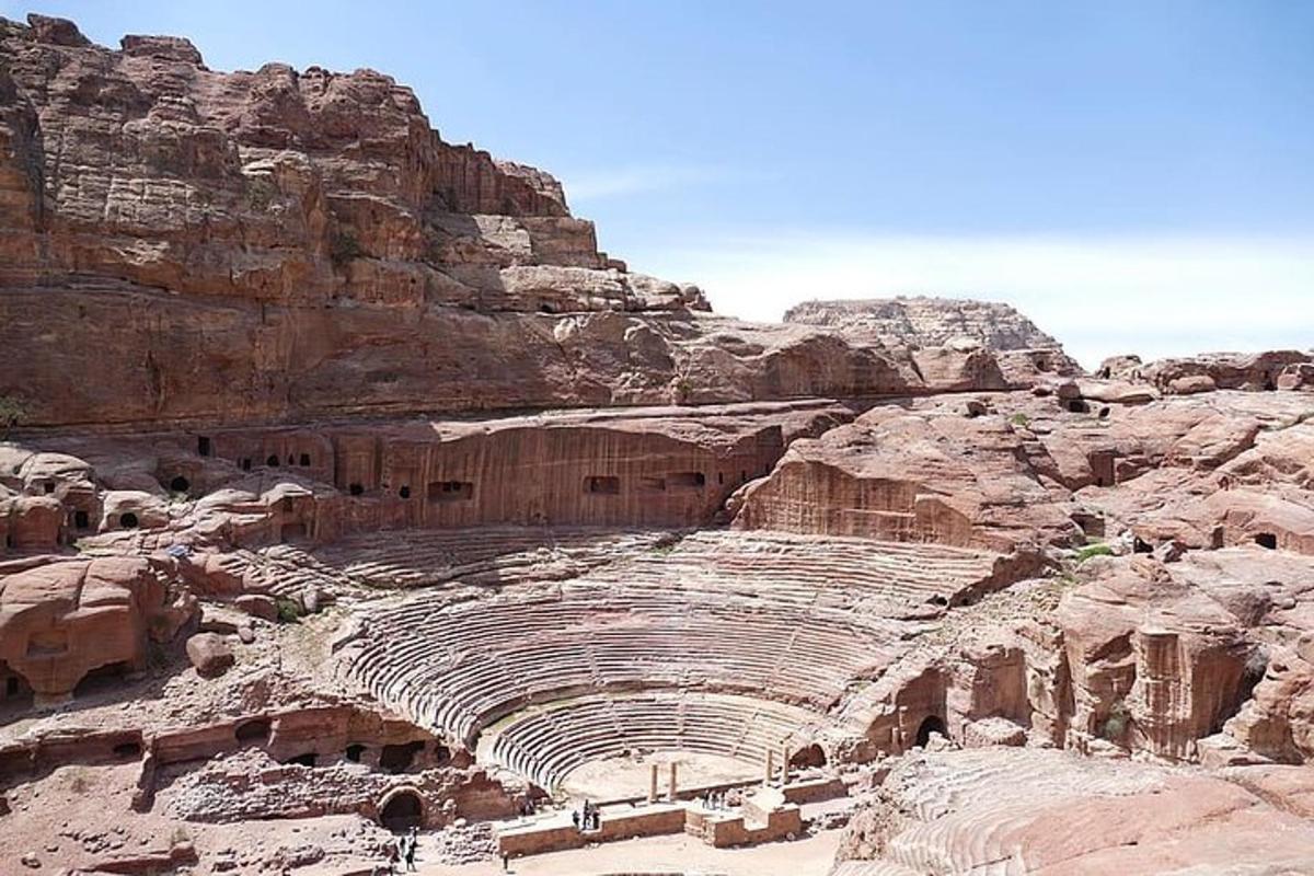 an ancient amphitheater in a canyon with a mountain