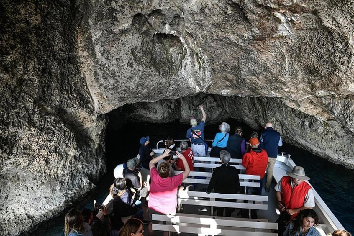a group of people on a boat in a cave