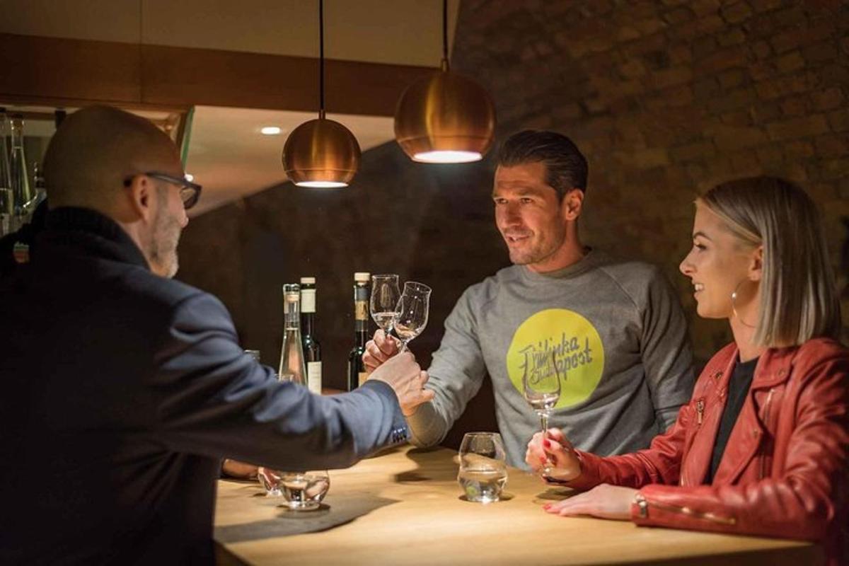 a man and woman shaking hands at a table with wine glasses