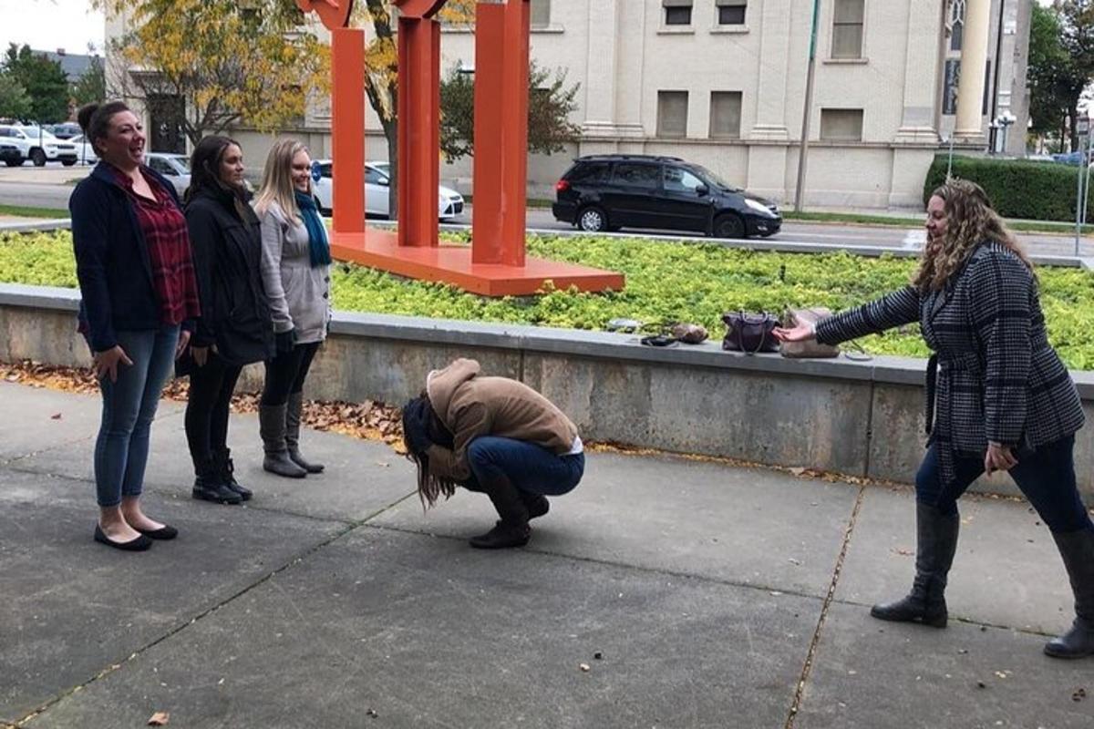 a group of people standing on a sidewalk