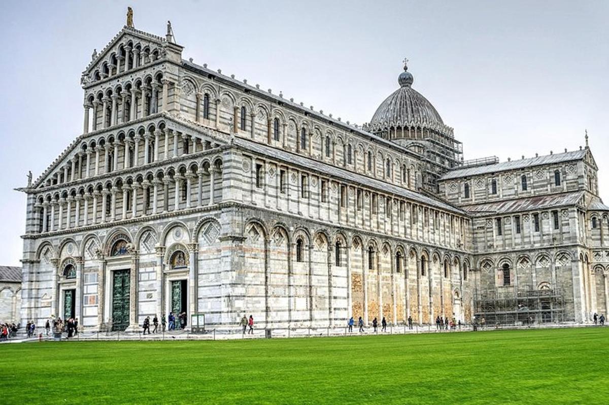 a large building with a green field in front of it