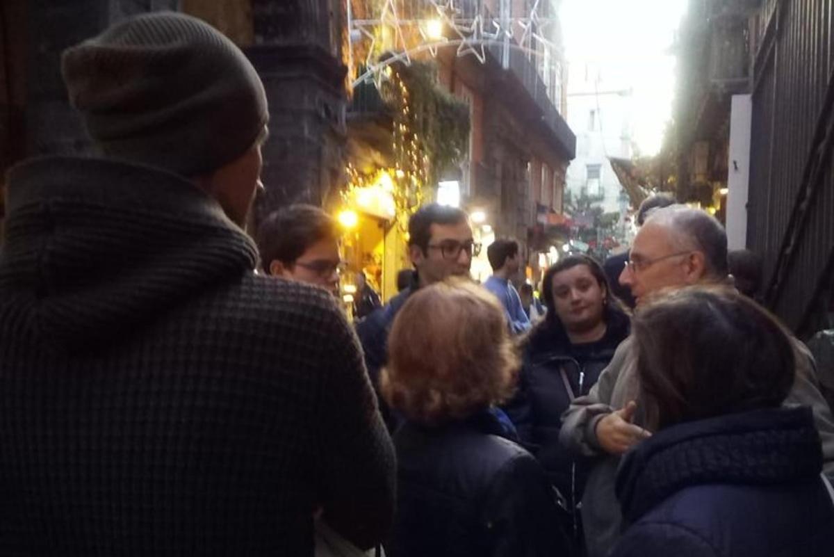 a crowd of people walking down a street