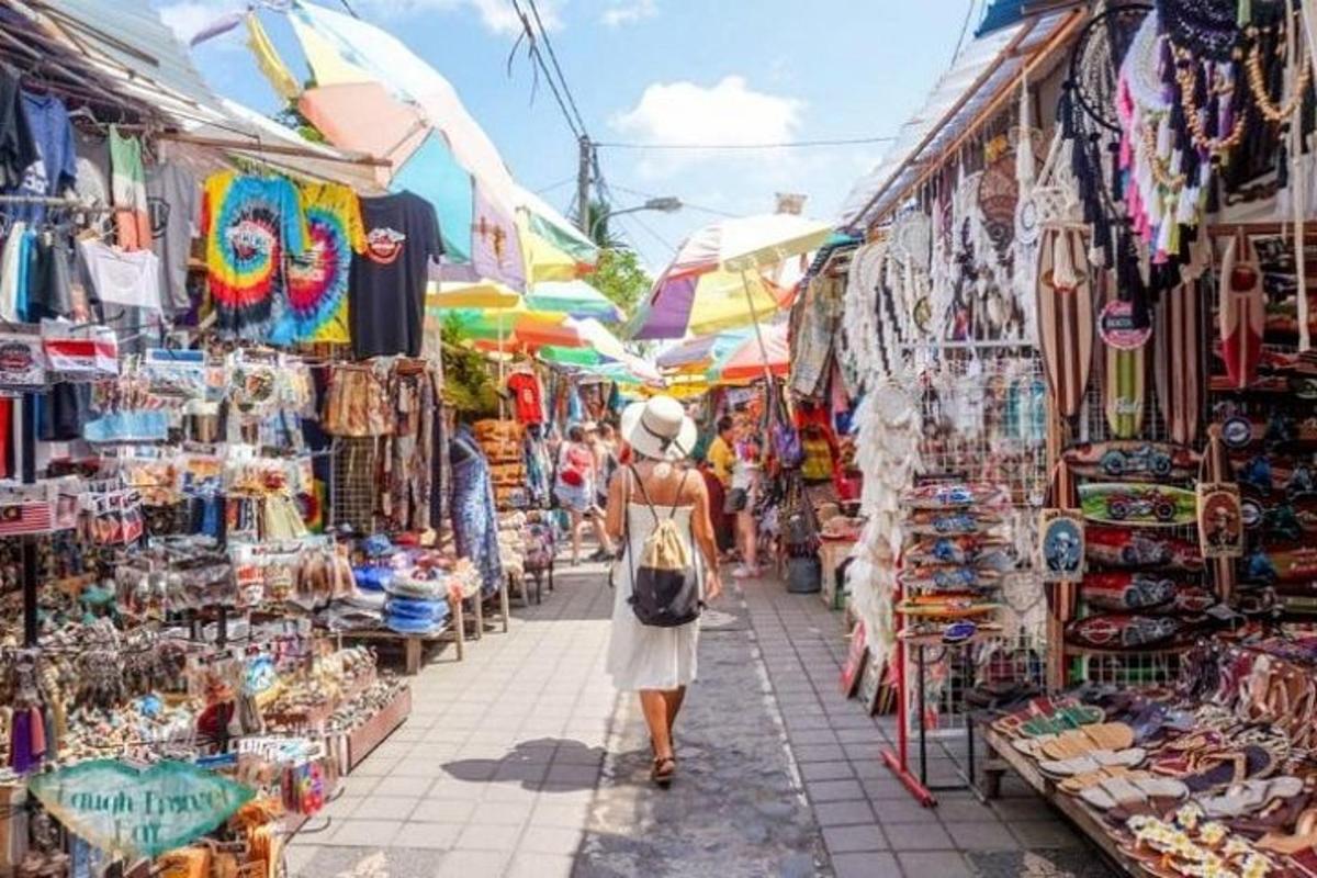 a woman walking through a market in cuba