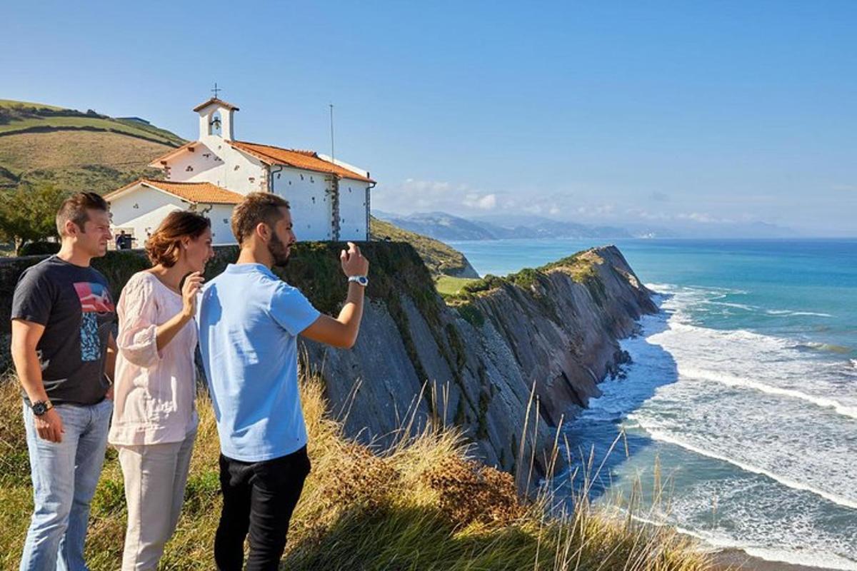 a group of people taking a picture of the ocean