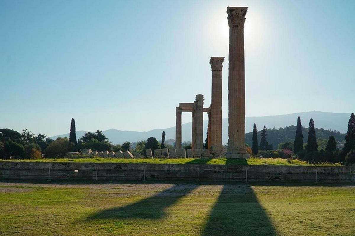 a monument with columns in a field of grass