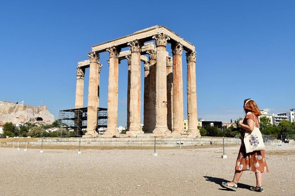 a woman walking in front of a large building