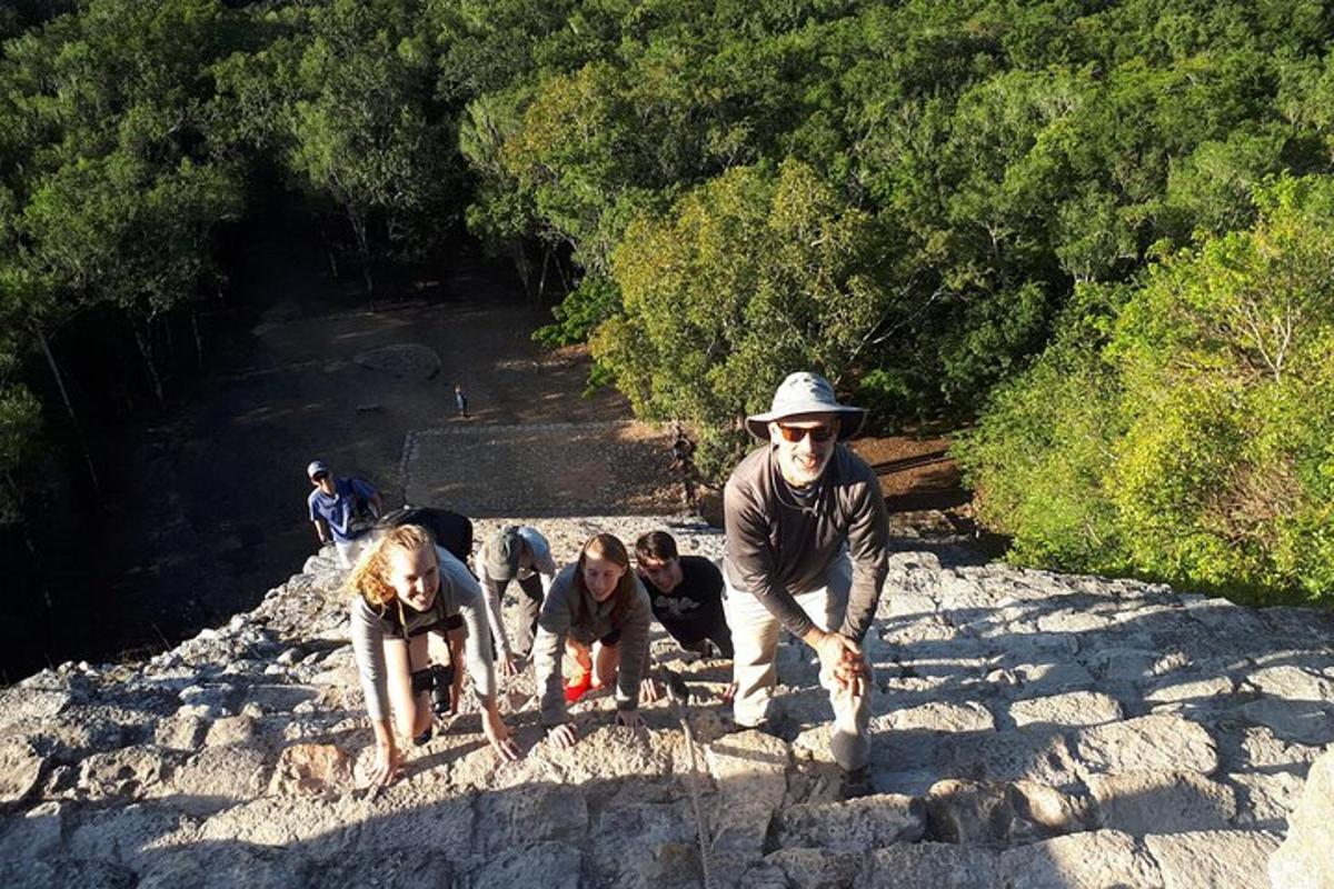 a group of people standing on some rocks