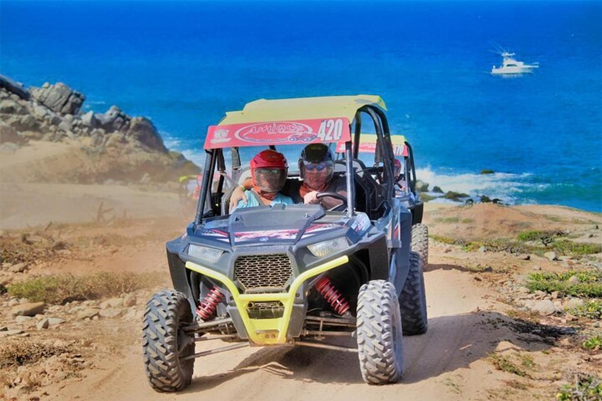 two people riding in a toyota off road vehicle