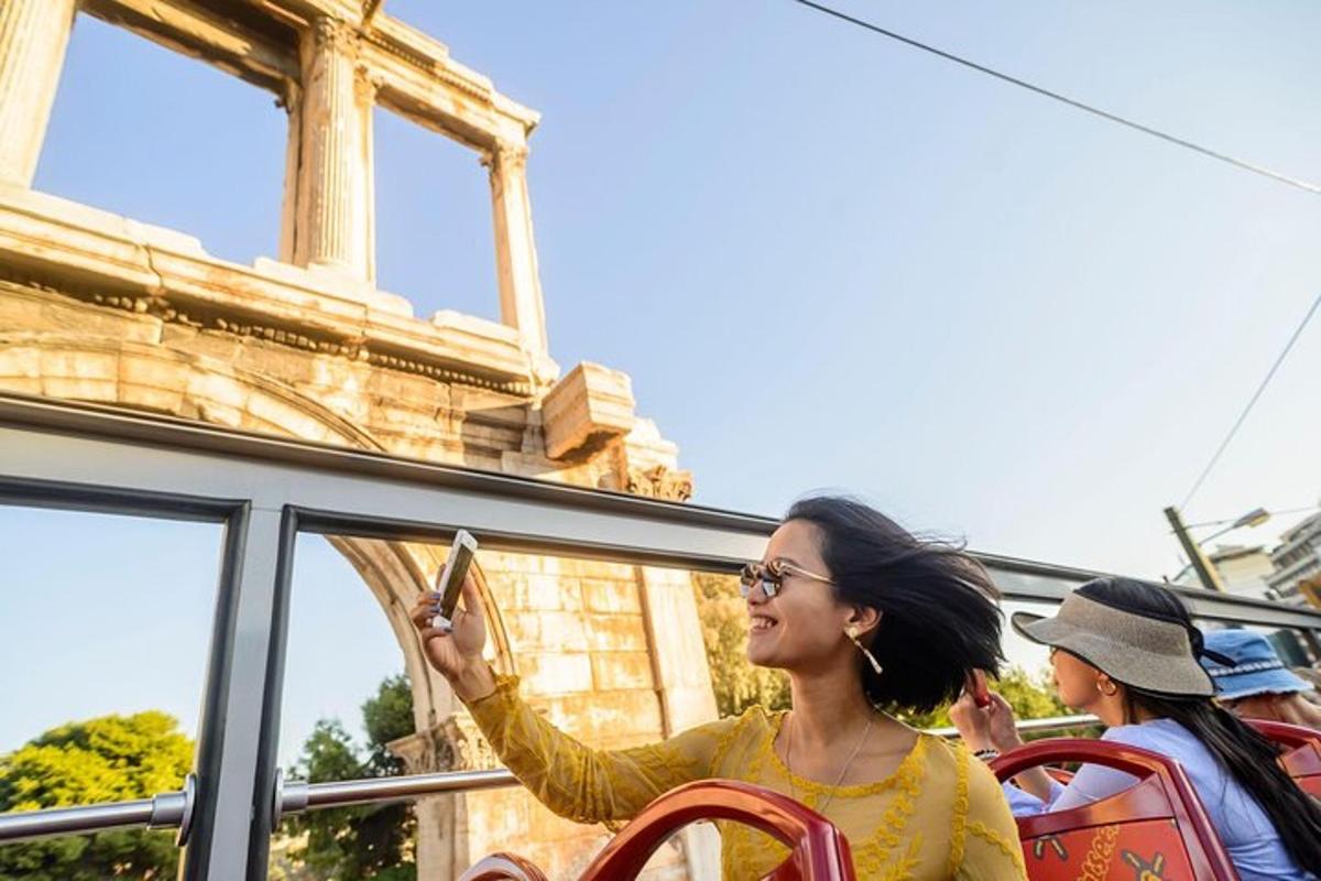 a woman sitting on a bus looking at her cell phone