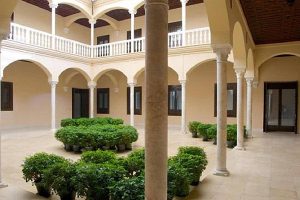 a building with a bunch of bushes in a courtyard