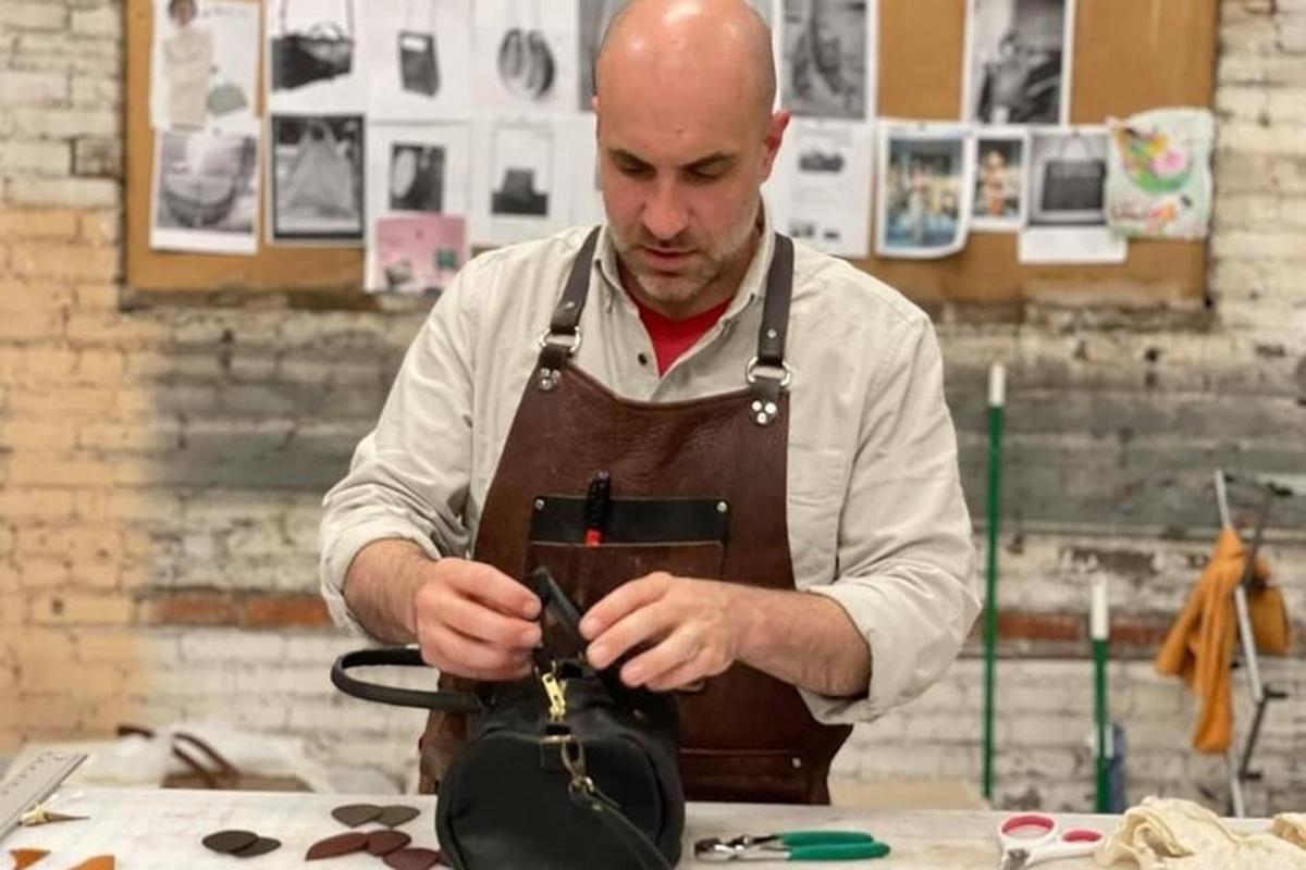 a man in a kitchen working on a bag