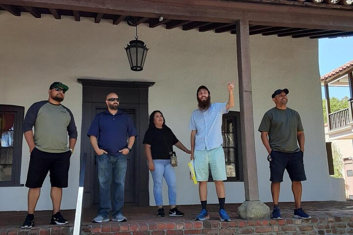 a group of people standing in front of a house