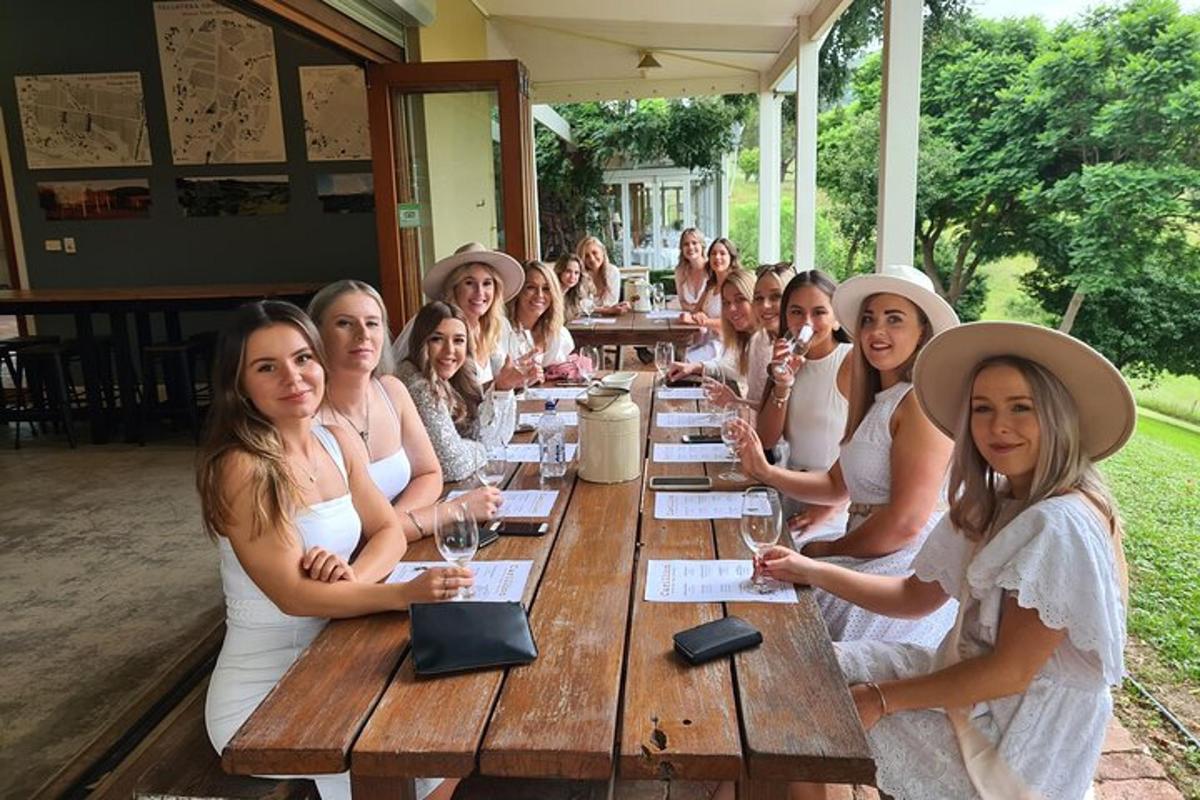 a group of women sitting at a long wooden table