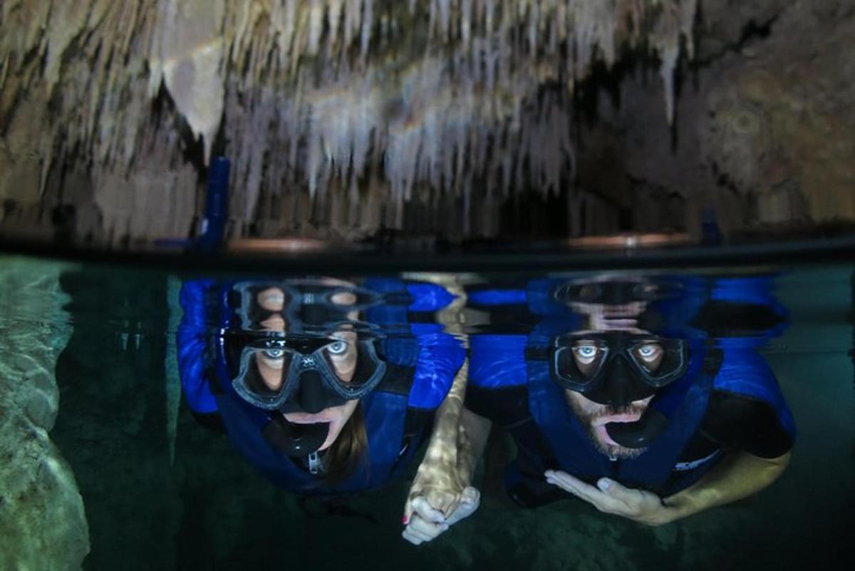 two people in the water in a pool