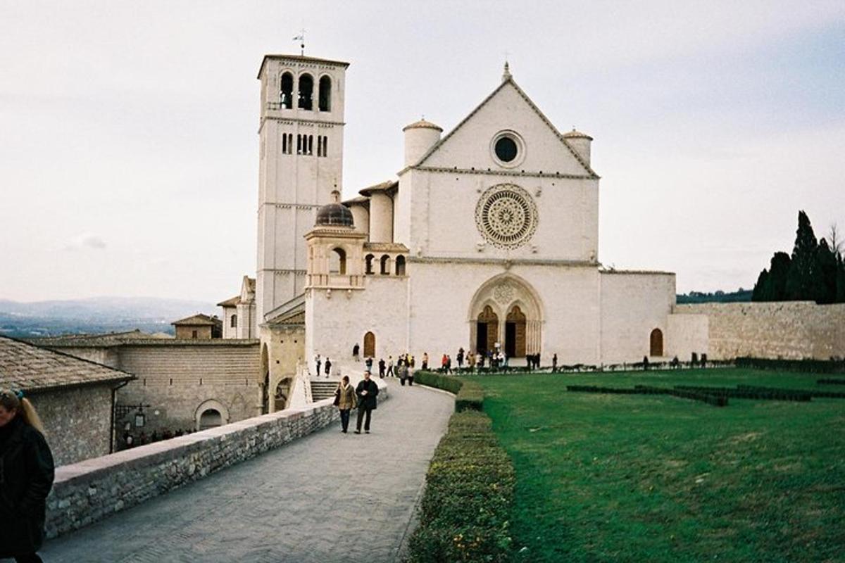 a large white church with a clock tower on a hill