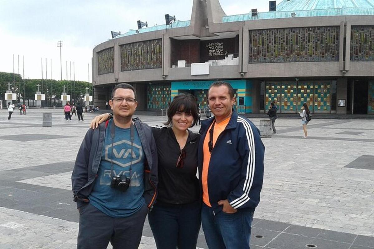 a group of three people standing in front of a building