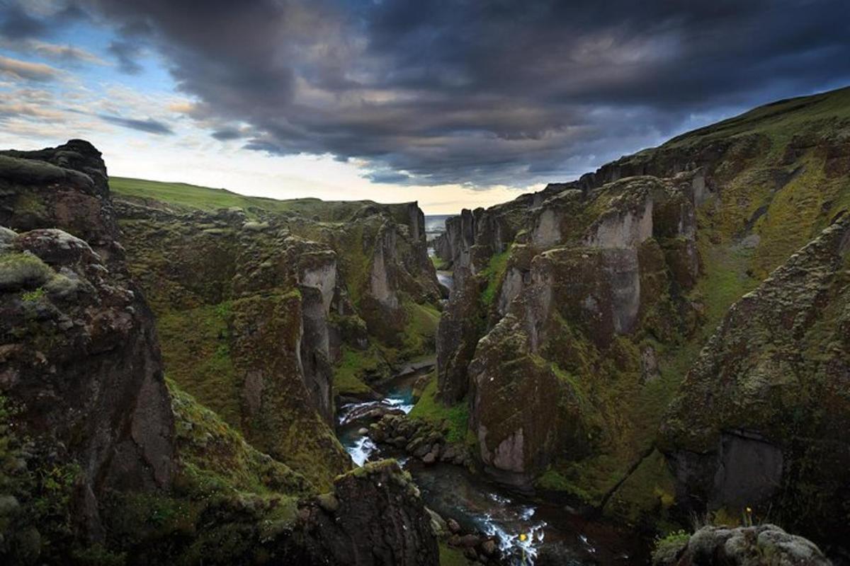 a view of a canyon with a river between two rocks