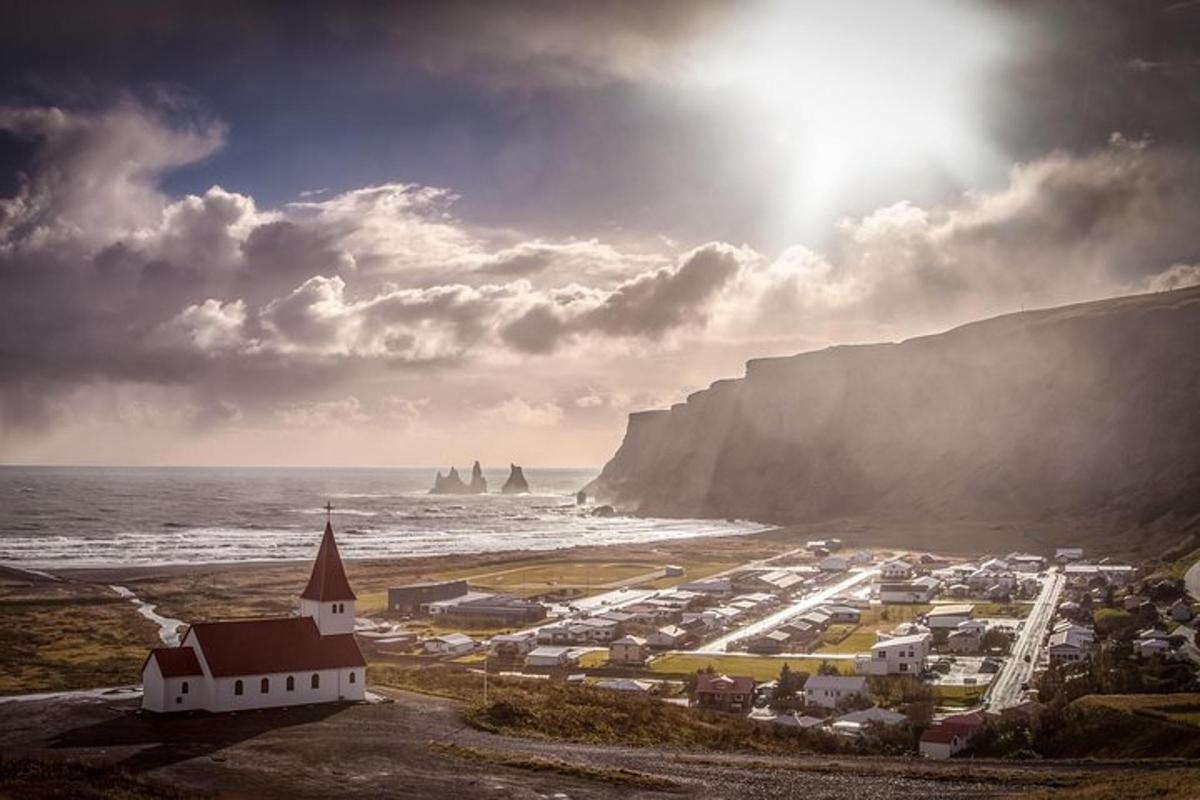 a view of a town with the ocean and cliffs