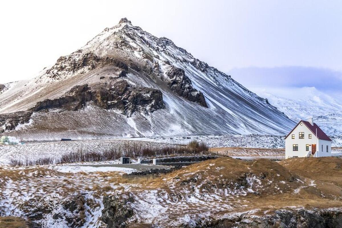 a house in front of a snow covered mountain