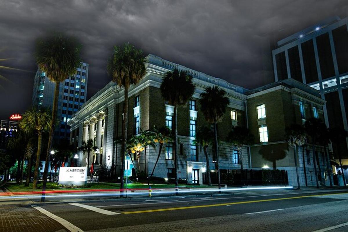 a large building with palm trees in front of it