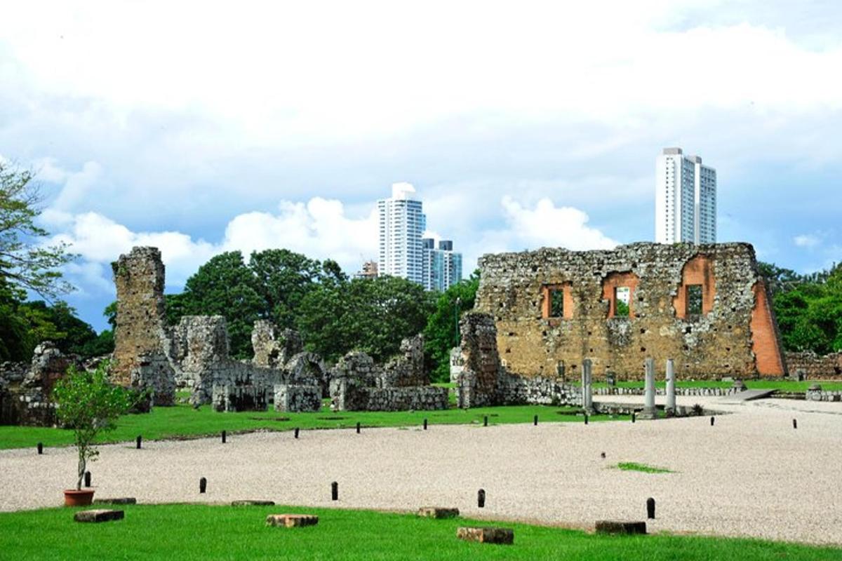 un edificio in pietra in un parco con edifici alti