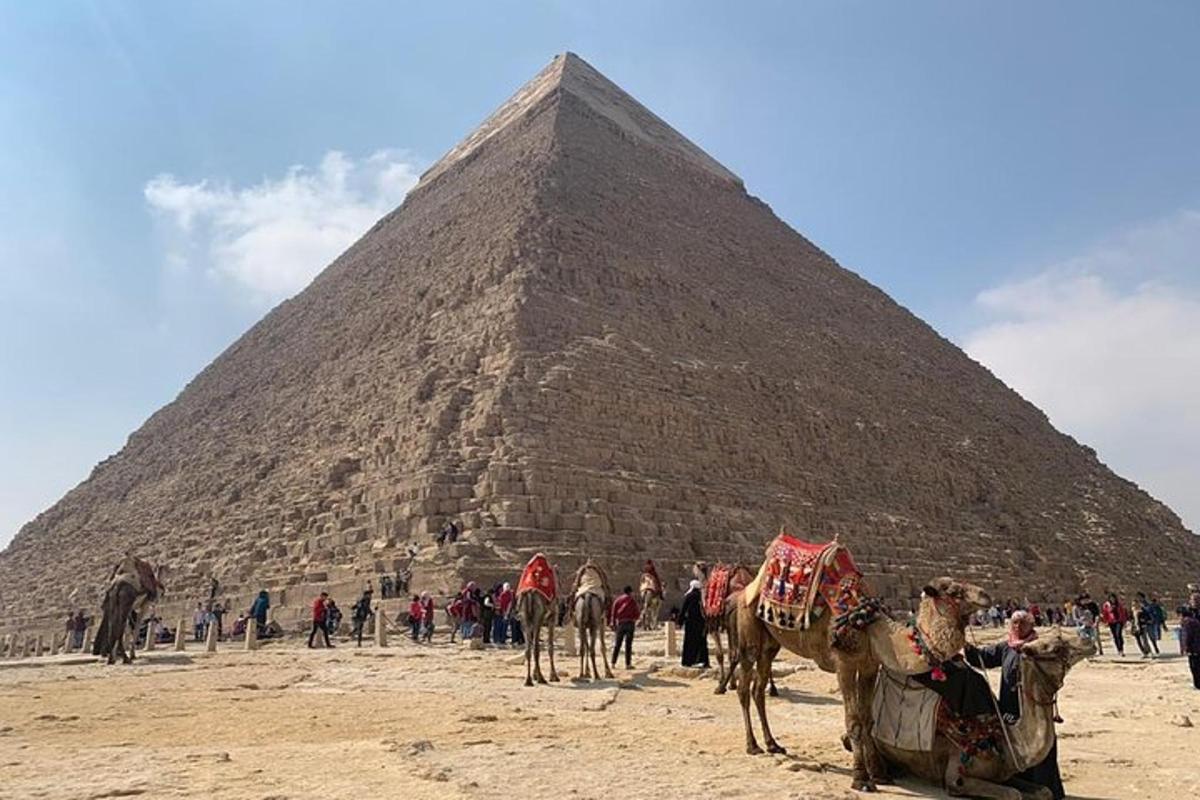 a group of people standing in front of a pyramid