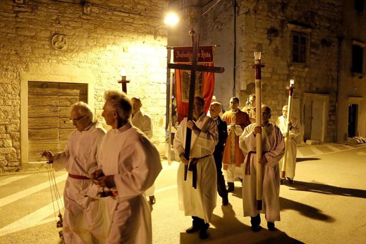 a group of priests walking in front of a church