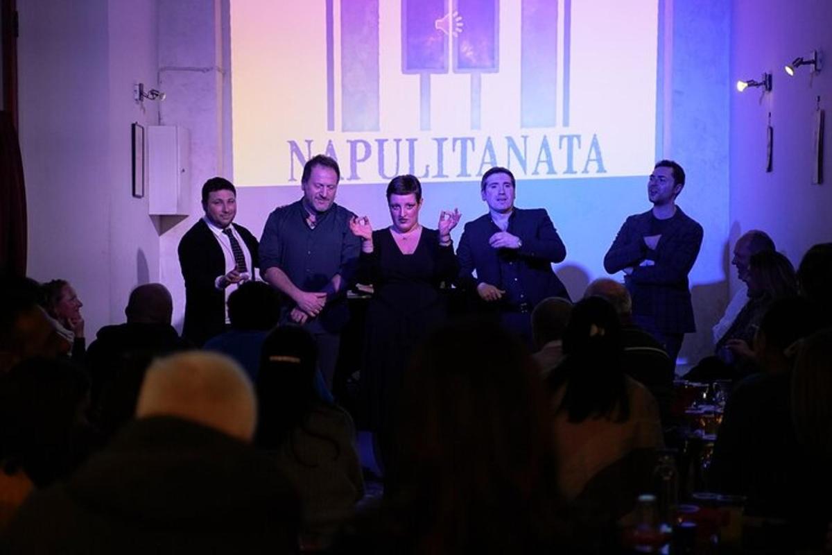 a group of men sitting in front of a stage