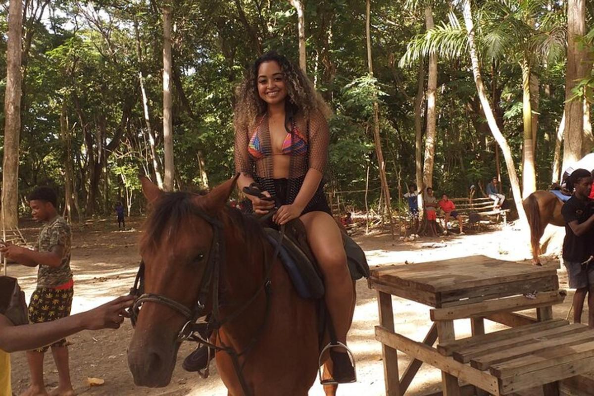 a woman in a bikini riding a horse