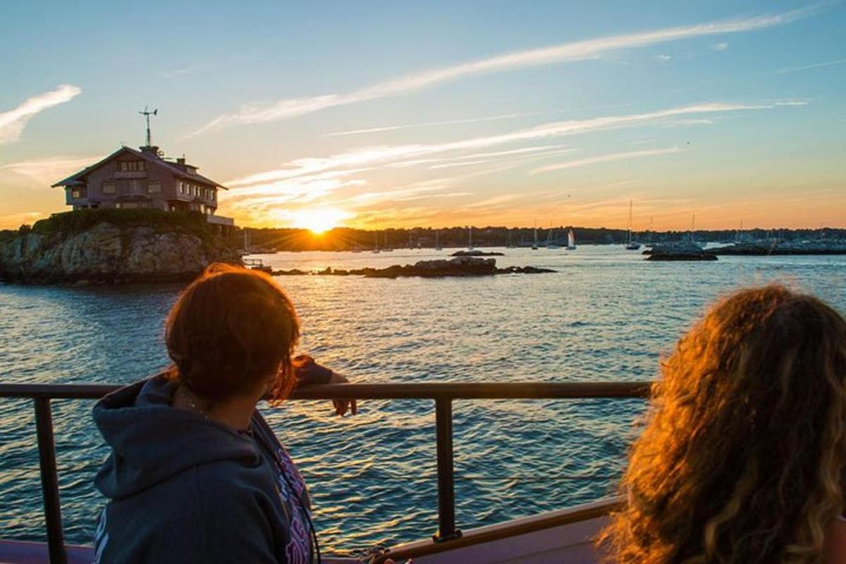 two people on a boat looking at the sunset