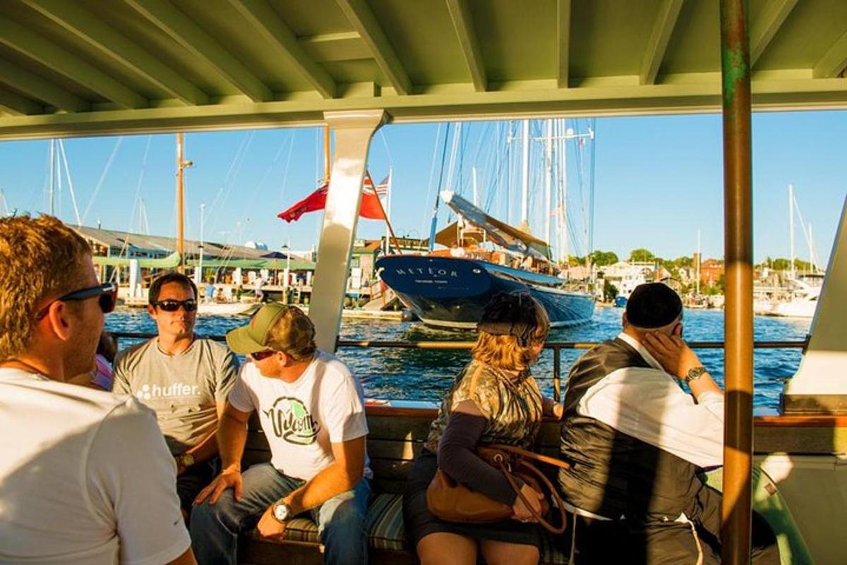 a group of people sitting on a boat in the water