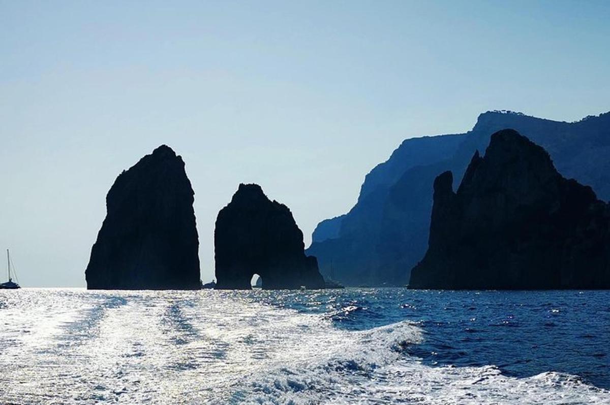 a boat in the water with mountains in the background