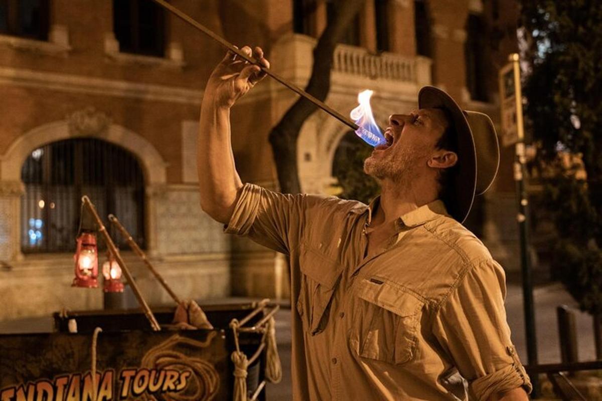 a man is drinking from a bottle with a straw