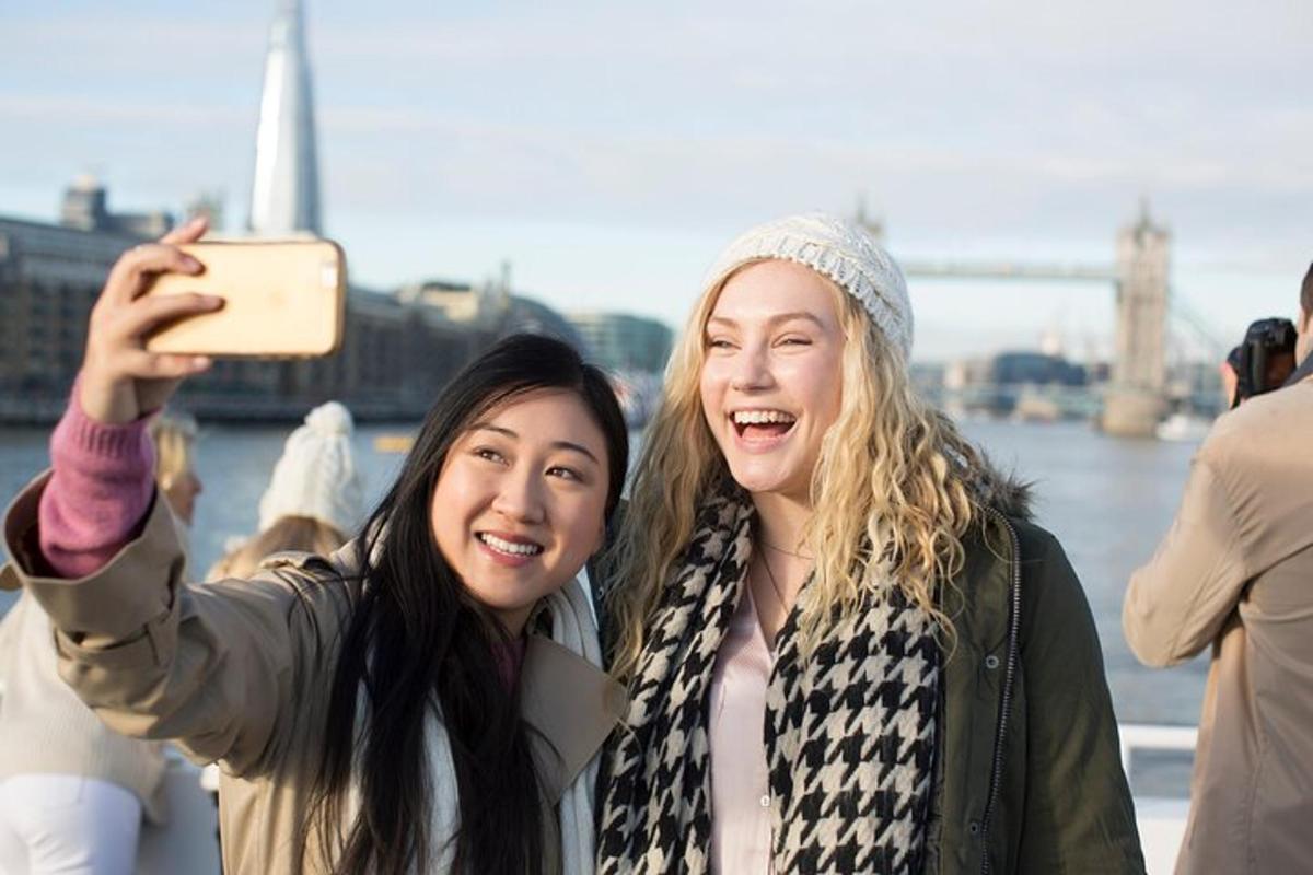 two women taking a picture with their cell phone