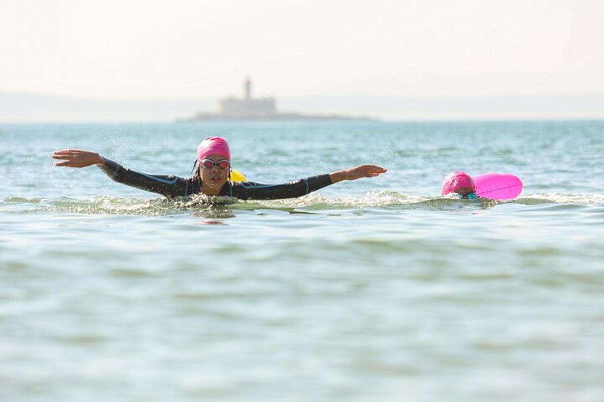 two people are swimming in the water