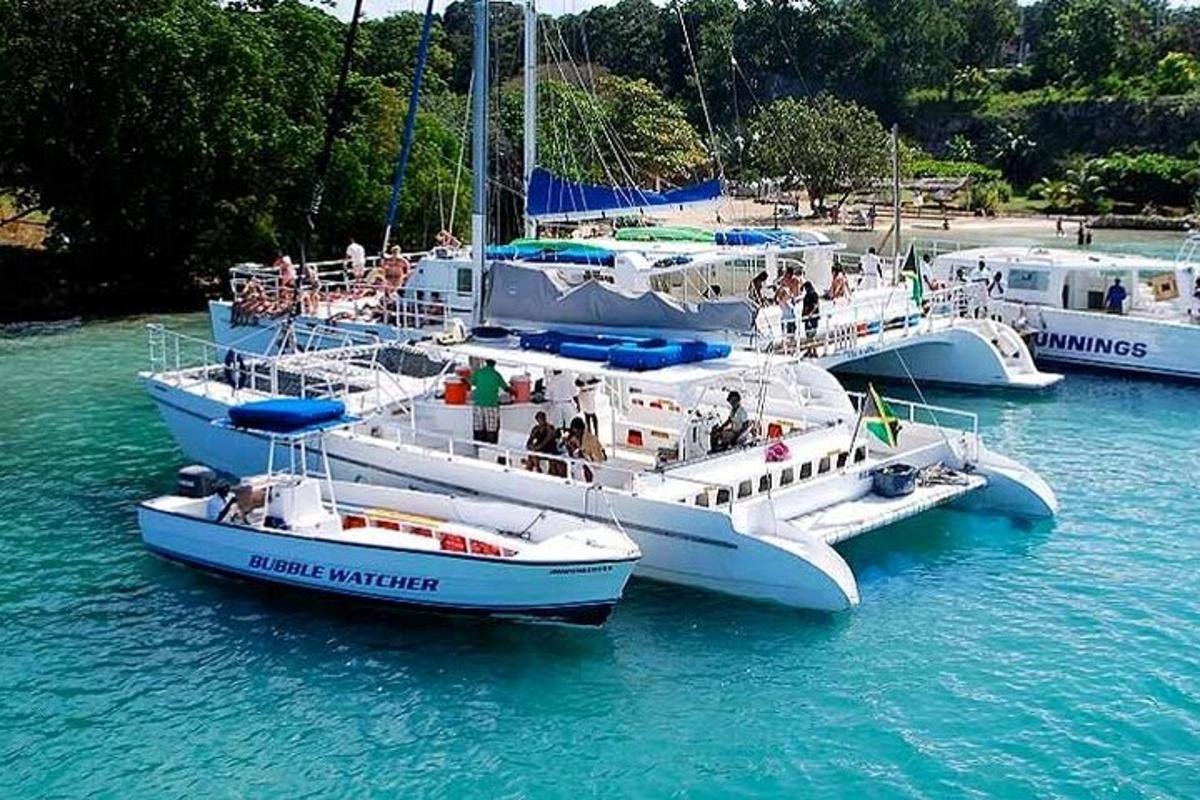 three boats in the water with people on them