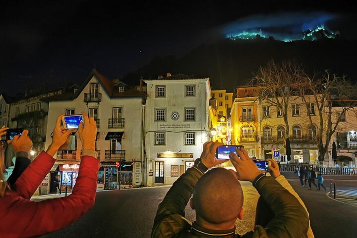 a group of people taking pictures with their cell phones