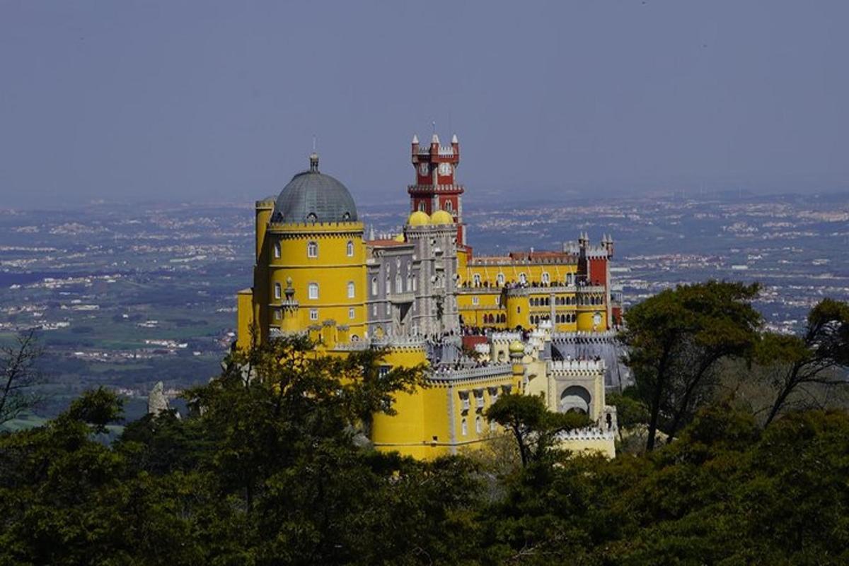 a large yellow building on top of a hill