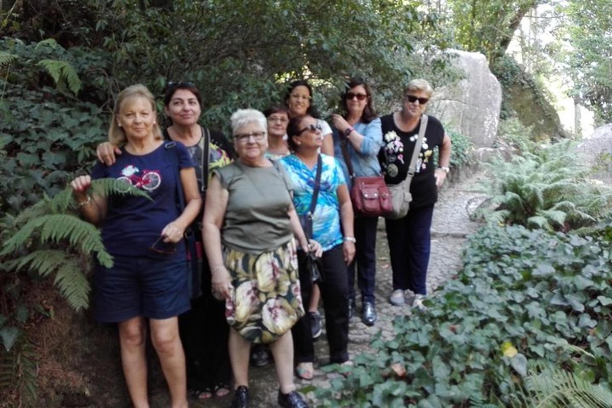 a group of women posing for a picture in a garden