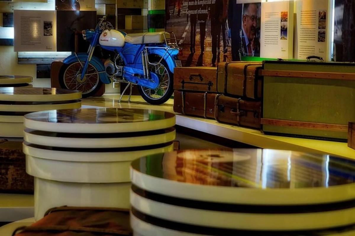 a blue motorcycle is on display in a museum