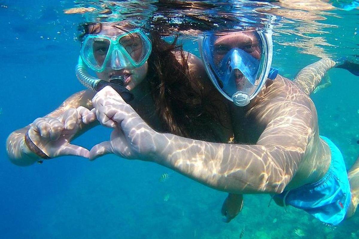 a woman in the water making a heart sign