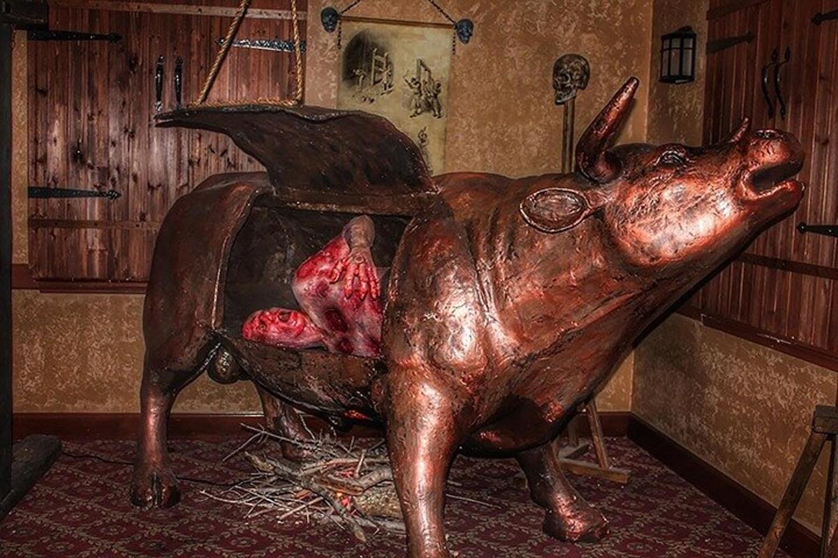 a statue of a pig sitting in a tub