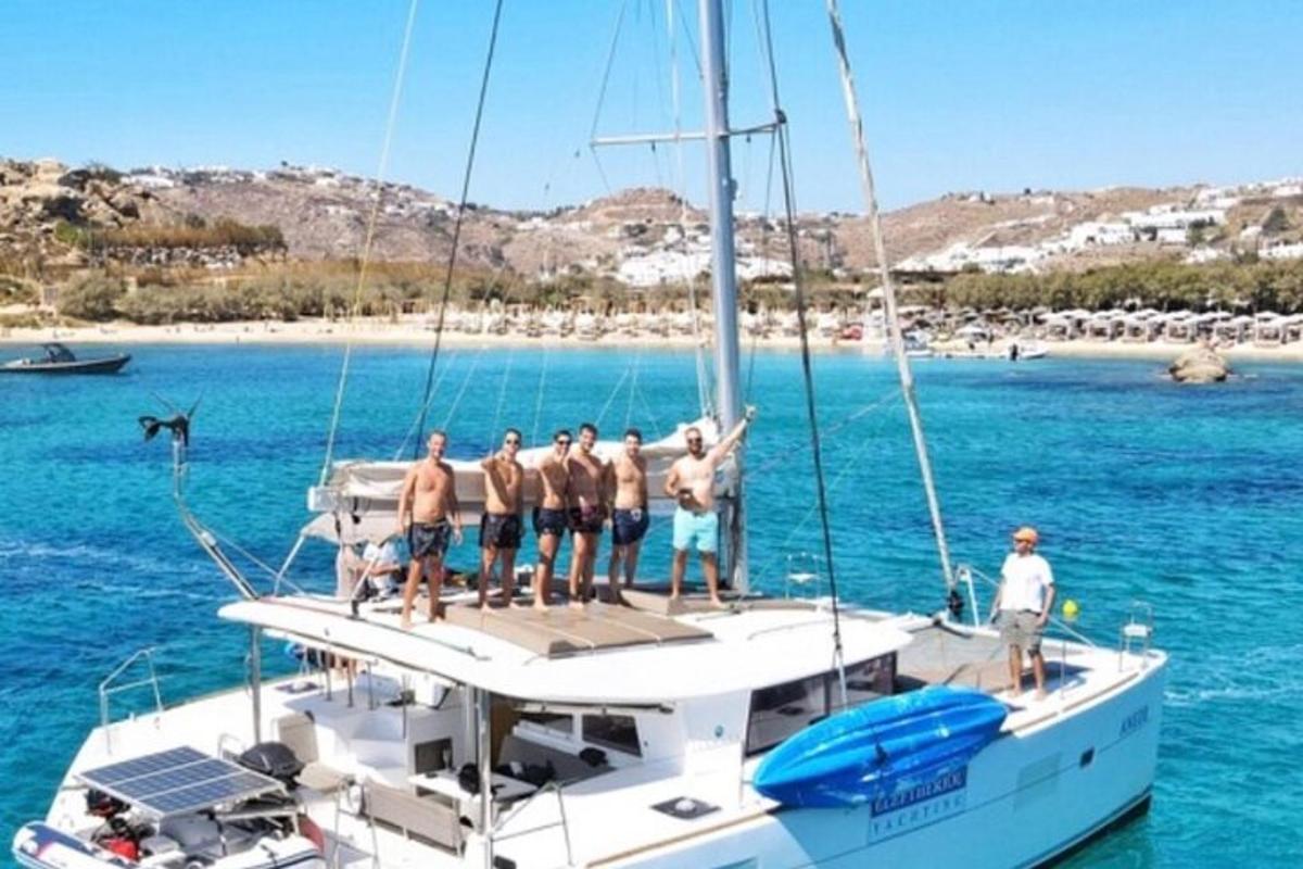 a group of men standing on a boat in the water