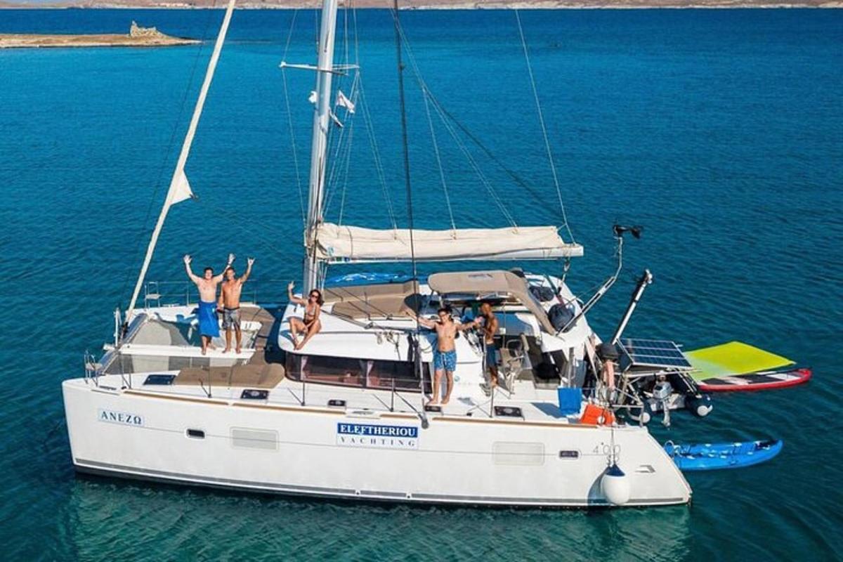 a group of people on a sailboat in the water
